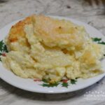 Greenbrier Garlic Potatoes are thinly sliced potatoes simmered in heavy cream, with fresh garlic, seasonings, eggs, and fresh parmesan cheese. They are then baked in this creamy sauce.