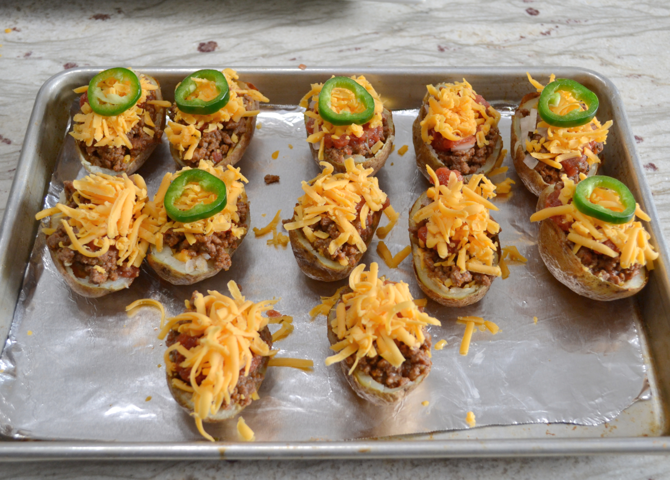 Southwestern Potato Skins are crispy oven baked potato skins loaded with taco meat, cheese, salsa, jalapenos and sour cream.