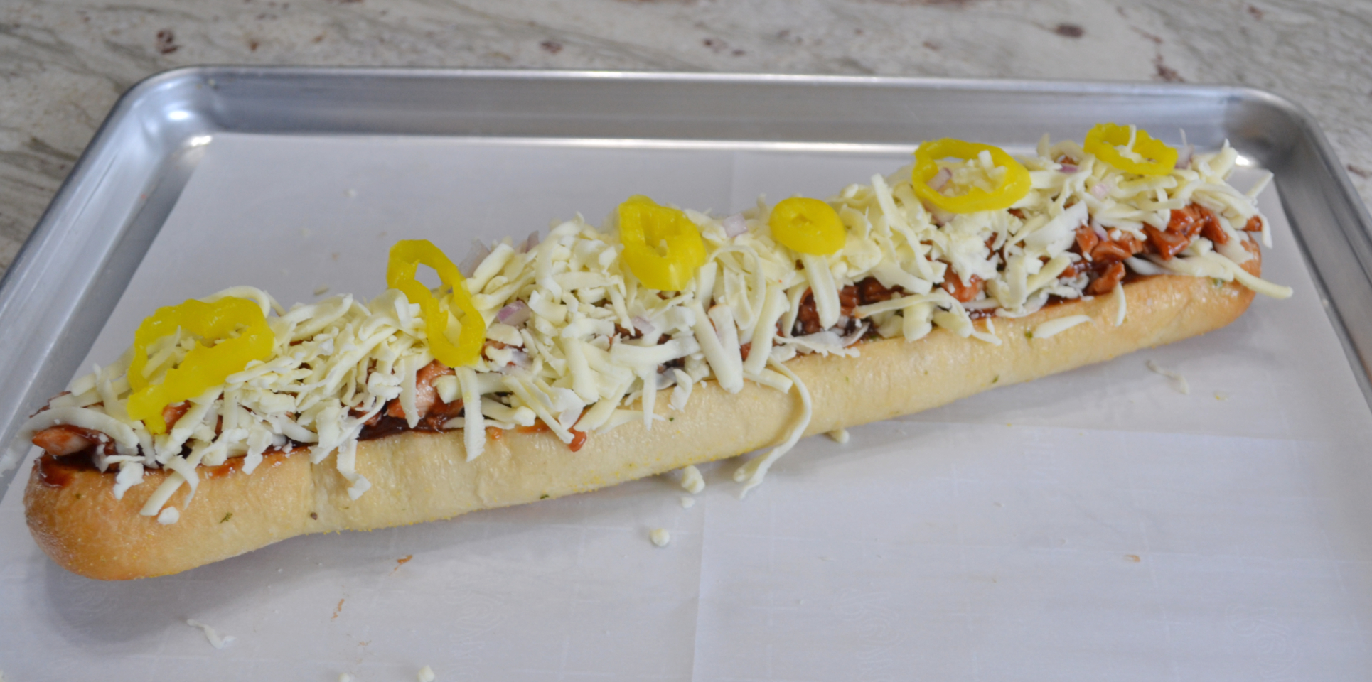 BBQ Chicken Garlic Bread Pizza ...frozen loaves of garlic bread, topped with  BBQ chicken, cheese, red onions, and banana peppers,  baked and ready to serve in minutes. 