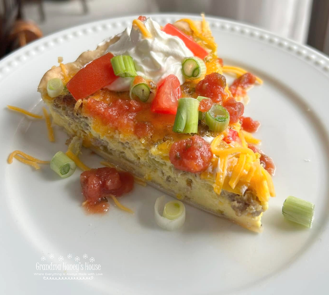 Southwest Breakfast Tart is packed with sausage, peppers, green chiles, cheese, eggs, and baked in a pie crust. It is served with toppings of salsa, sour cream, green onions and diced tomatoes.  