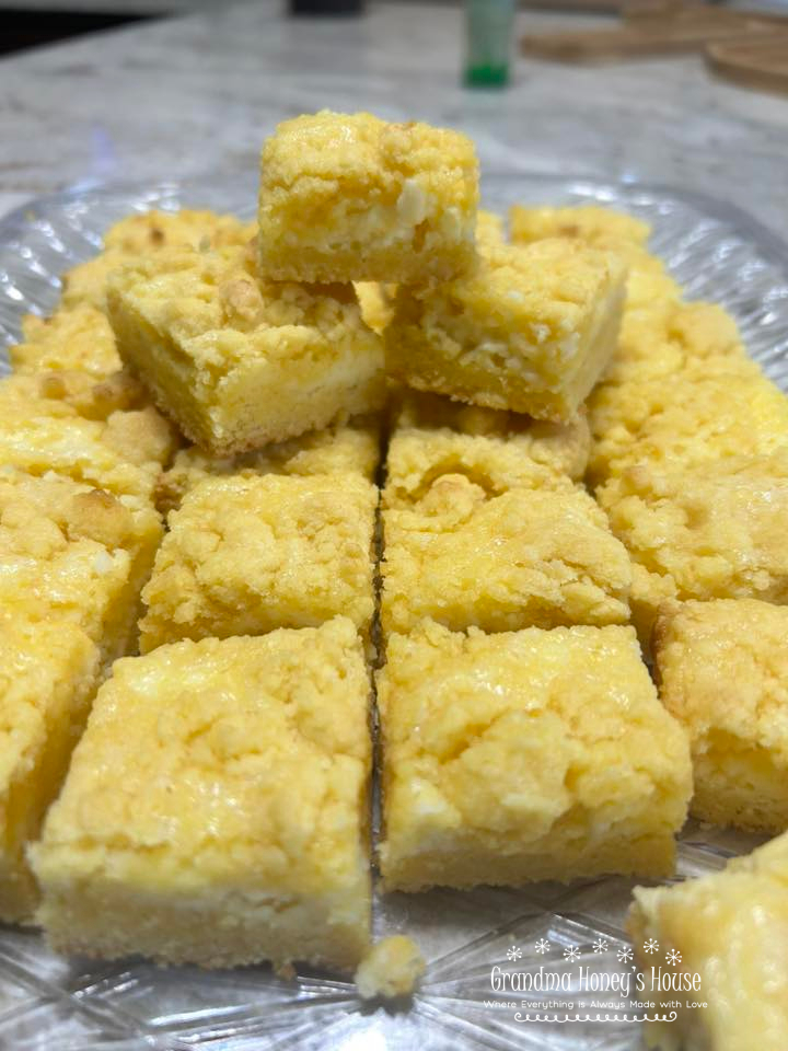 Easy cheesecake bars using a cake mix as a base, cream cheese and Lemon filling, topped with a crumble of the cake mix mixture.
