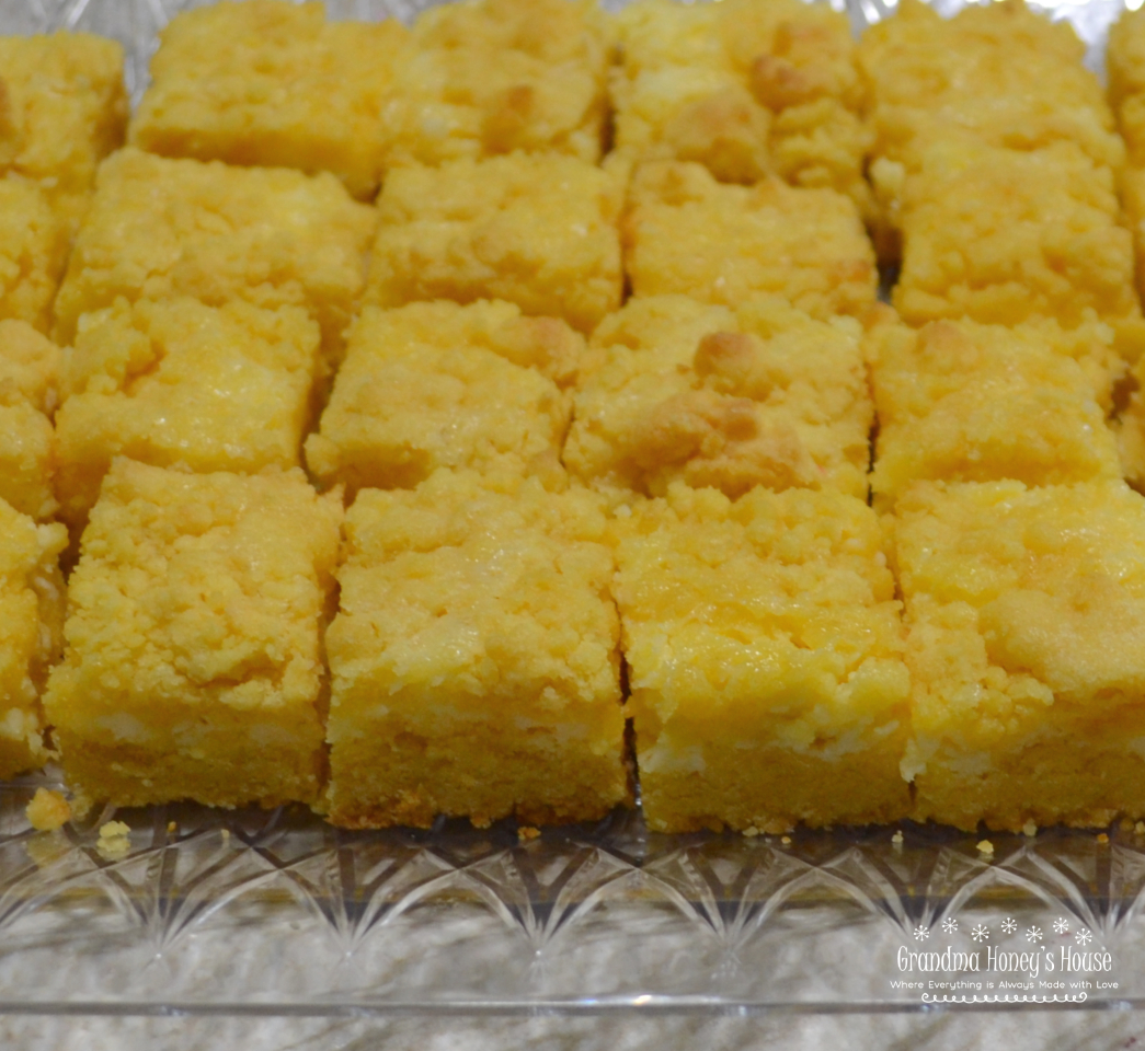 Easy cheesecake bars using a cake mix as a base, cream cheese and Lemon filling, topped with a crumble of the cake mix mixture.