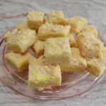 Easy cheesecake bars using a cake mix as a base, cream cheese and Lemon filling, topped with a crumble of the cake mix mixture.