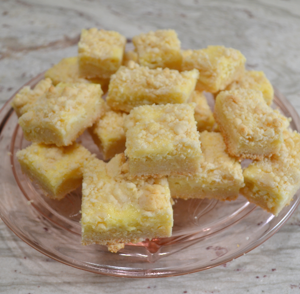 Easy cheesecake bars using a cake mix as a base, cream cheese and Lemon filling, topped with a crumble of the cake mix mixture.