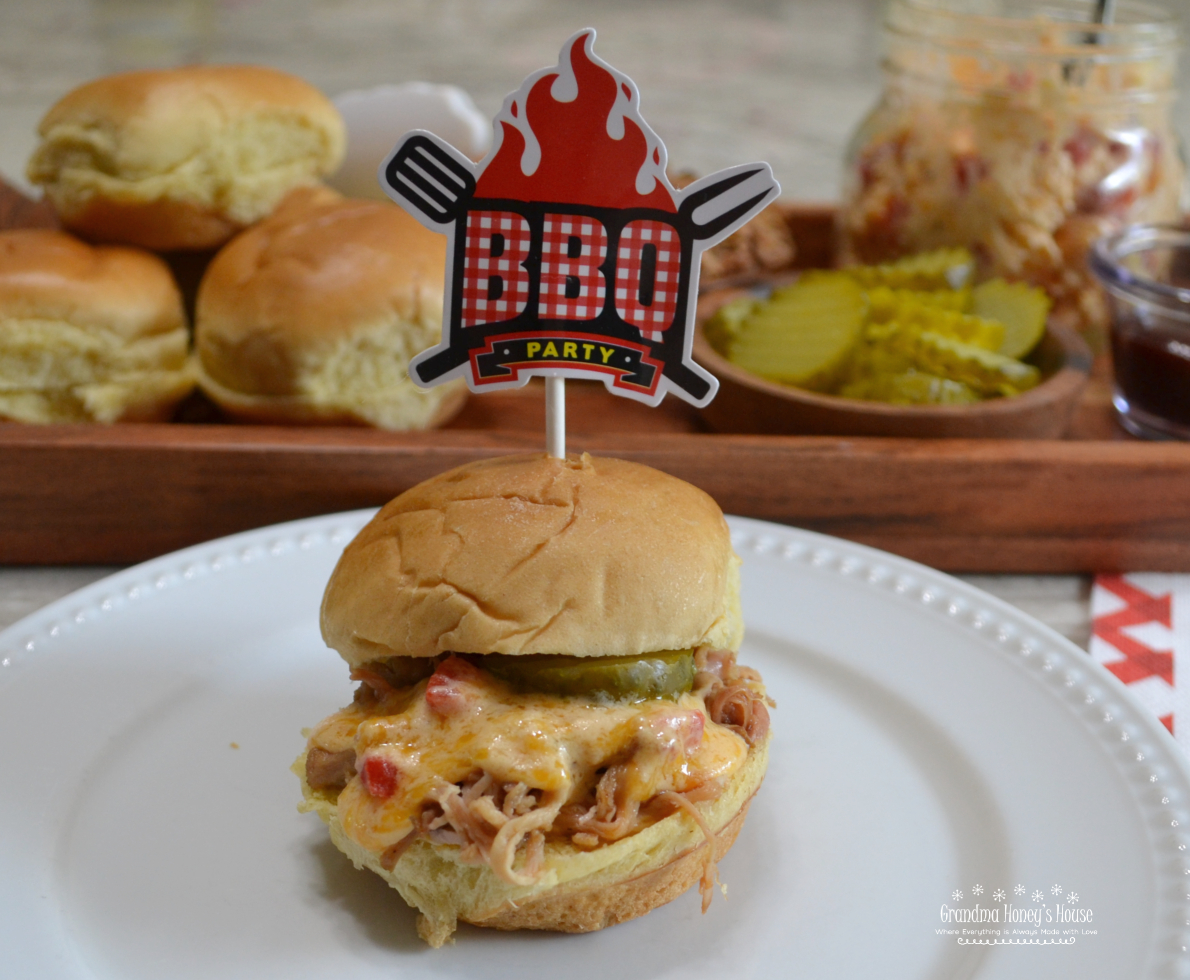 Pulled Pork Pimento Cheese Sliders. Tender, slow cooked pulled pork with warm, melted, spicy pimento cheese and served on a slider bun.