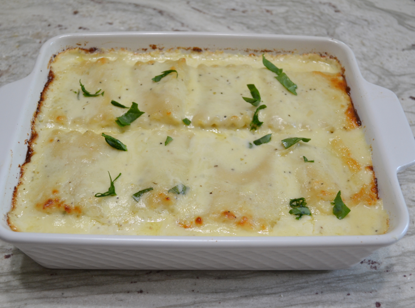 Chicken-Spinach Alfredo Roll-Ups is a comfort food meal you will want to make frequently. A mixture of ricotta, mozzarella and parmesan cheese, egg, baby spinach, and chopped rotisserie chicken are spread on a tender lasagna noodle and then rolled up. They are baked in a homemade alfredo sauce and covered with more cheese.