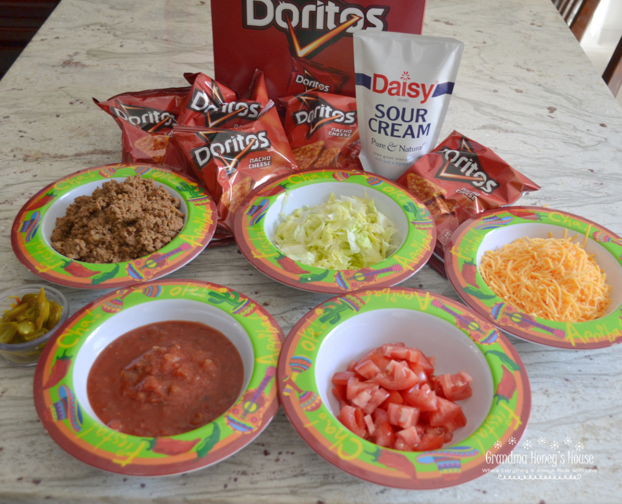 Tacos in a Bag are a fun meal that we have been eating here in WV for years. A small bag of Doritos (or Fritos) is filled with cooked taco meat and a variety of toppings such as cheese, salsa, diced tomatoes, and sour cream.