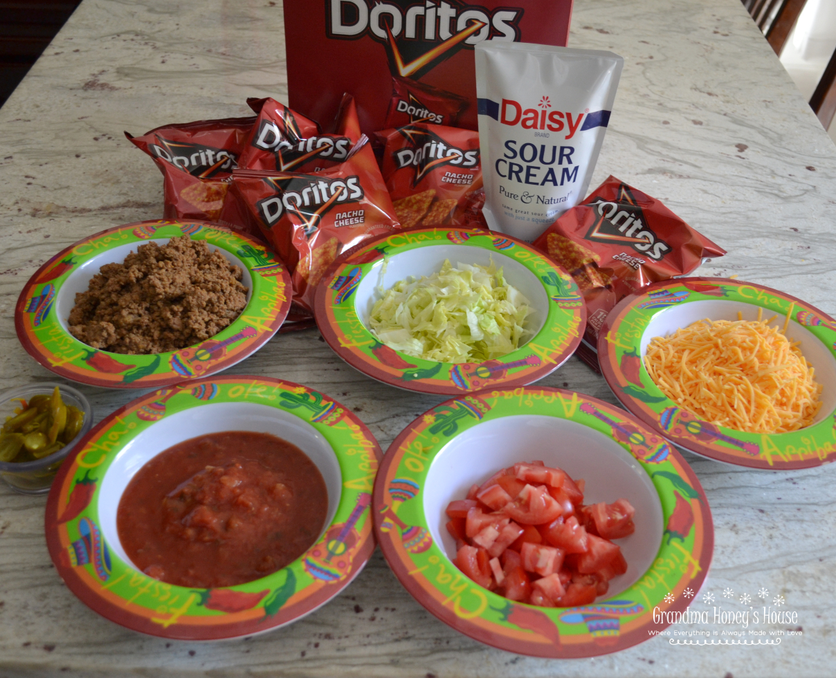 Tacos in a Bag are a fun meal that we have been eating here in WV for years. A small bag of Doritos (or Fritos) is filled with cooked taco meat and a variety of toppings such as cheese, salsa, diced tomatoes, and sour cream.