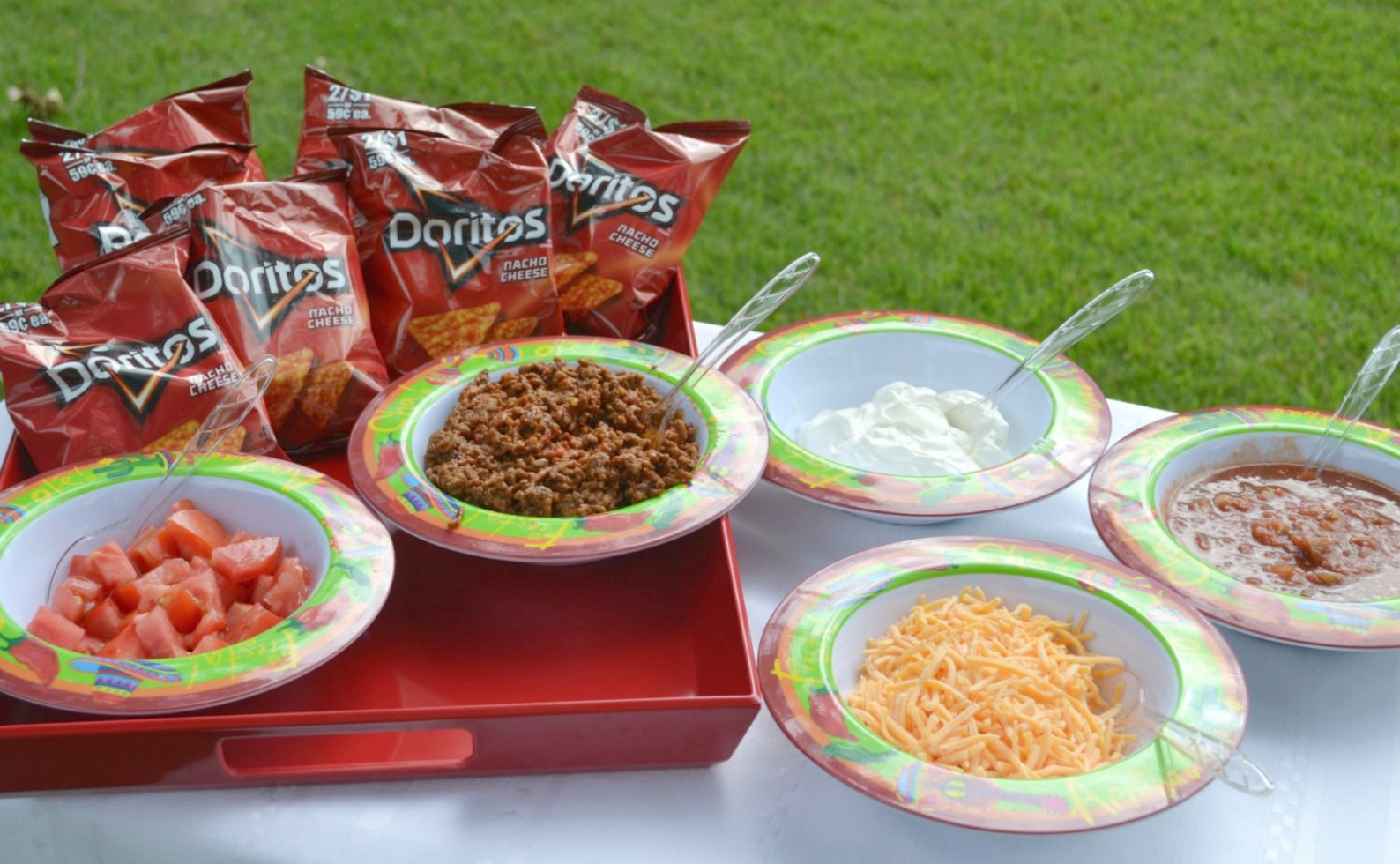 Tacos in a Bag are a fun meal that we have been eating here in WV for years. A small bag of Doritos (or Fritos) is filled with cooked taco meat and a variety of toppings such as cheese, salsa, diced tomatoes, and sour cream.