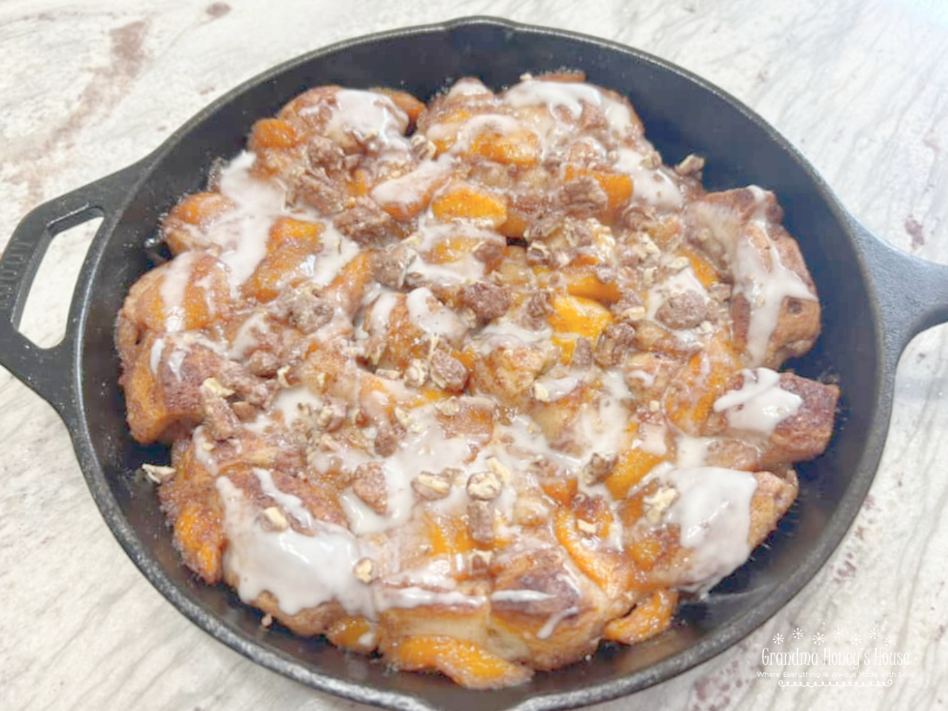 Cinnamon Roll Peach Cobbler Skillet.... a mixture of fresh peaches, cinnamon, sugar and vanilla, poured over a crust of refrigerated cinnamon rolls in a cast iron skillet and baked
