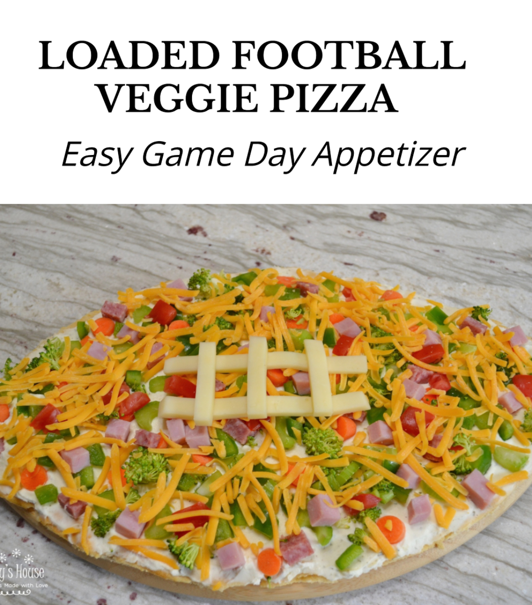 Loaded football veggie pizza is a crescent crust in a football shape, covered with cream cheese filling, veggies, meat and cheese. The perfect appetizer.