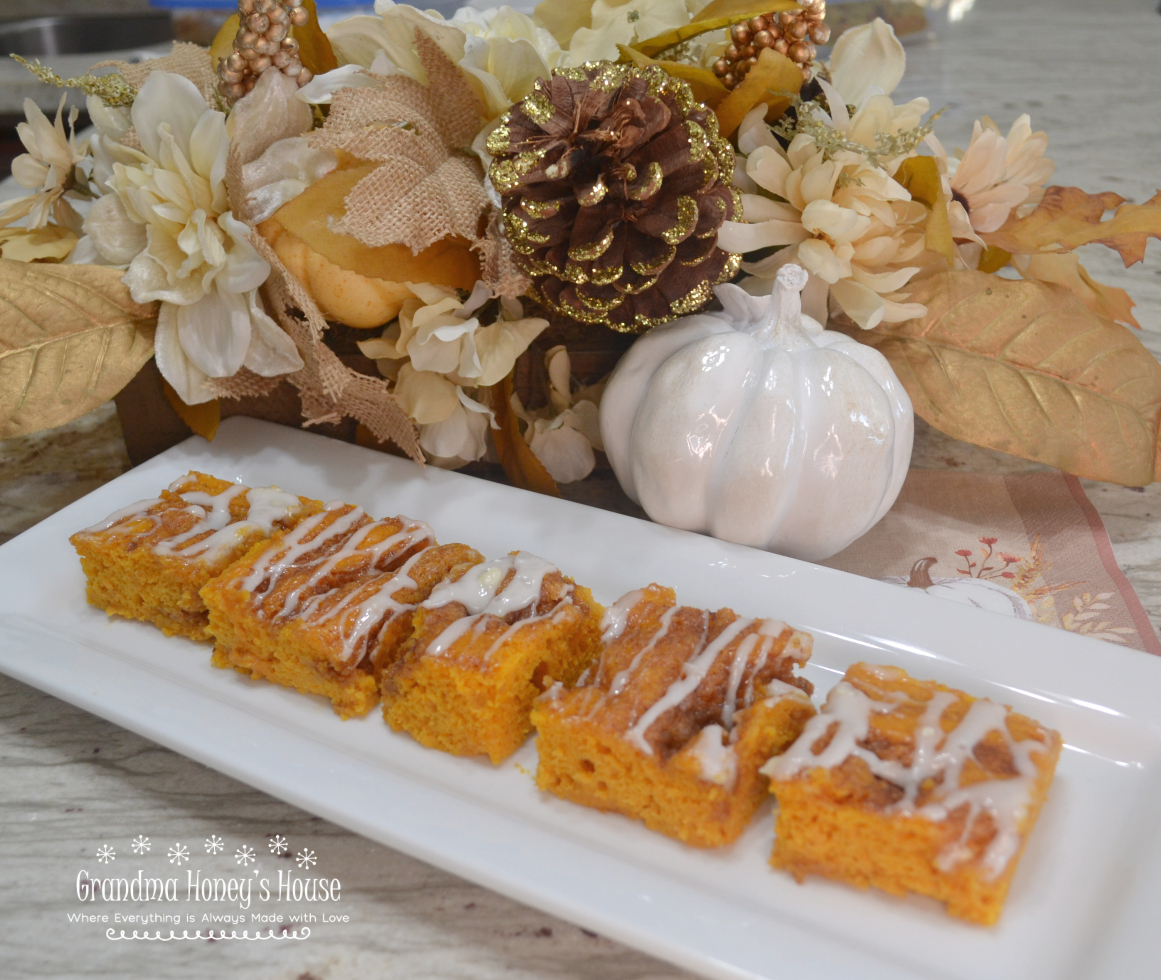 Pumpkin Cinnamon Roll Sheet Cake is perfect to serve at Thanksgiving, a cake mix batter that is swirled with a buttery cinnamon sugar filling, baked and topped with a mascarpone glaze and chopped pecans. 