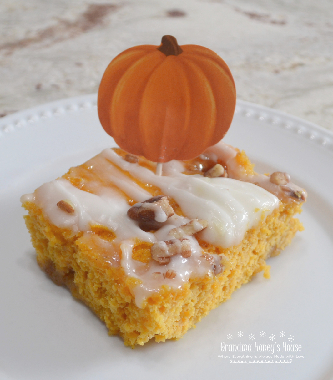 Pumpkin Cinnamon Roll Sheet Cake is perfect to serve at Thanksgiving, a cake mix batter that is swirled with a buttery cinnamon sugar filling, baked and topped with a mascarpone glaze and chopped pecans. 