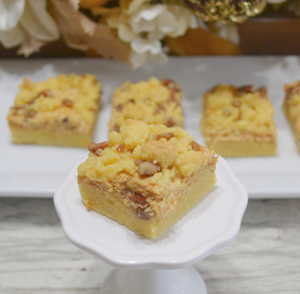 Pumpkin Streusel Cream Cheese Bars are made with a yellow cake mix base, a filling of cream cheese, egg, sugar, and pumpkin, then topped with a streusel topping and baked.