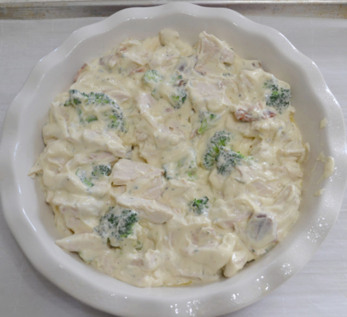 A creamy chicken casserole with bacon, ranch, broccoli and then topped with shredded tater tots and cheddar cheese. It is baked until cheese is melted and mixture is bubbly.