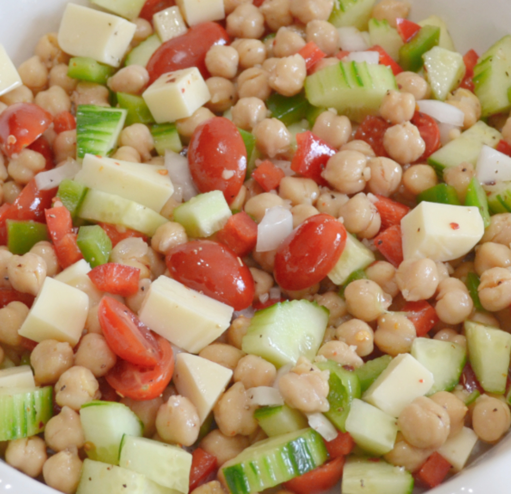 Cucumber and Chickpea Salad is a colorful and easy to make summer salad or side dish made with chickpeas, cucumbers, tomatoes, peppers, onions and provolone cheese. It is drizzled with a tangy dressing and chilled.&nbsp;
