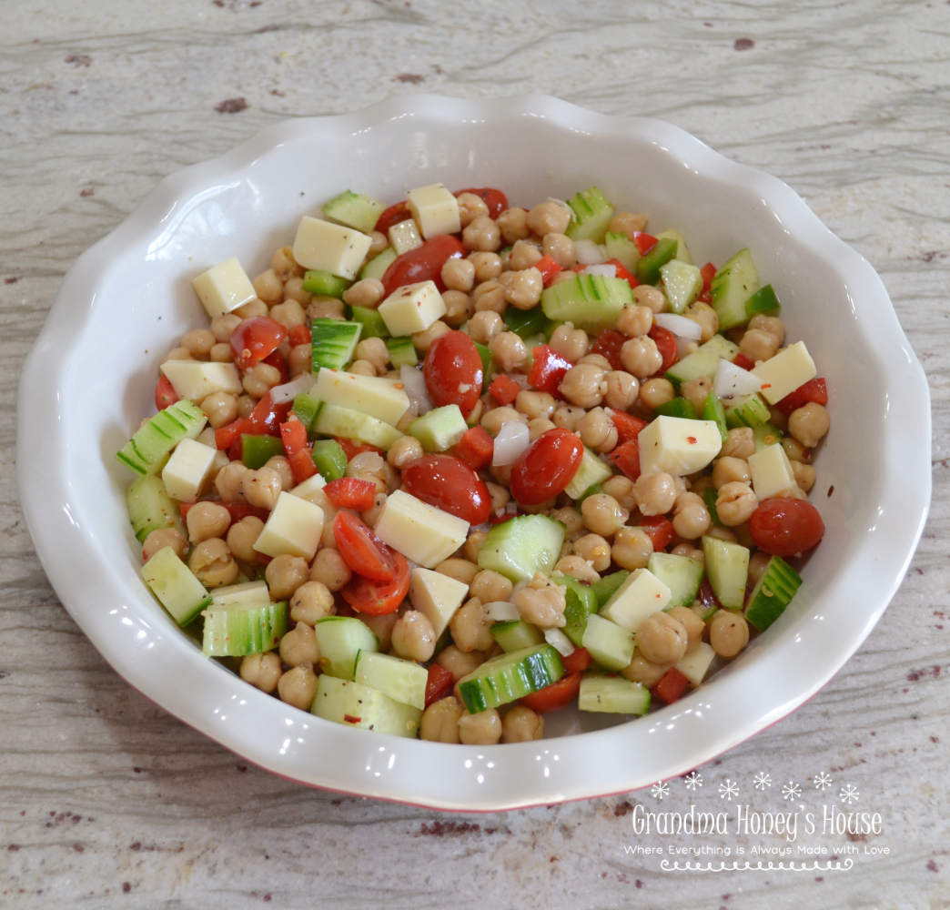 Cucumber and Chickpea Salad is a colorful and easy to make summer salad or side dish made with chickpeas, cucumbers, tomatoes, peppers, onions and provolone cheese. It is drizzled with a tangy dressing and chilled.&nbsp;