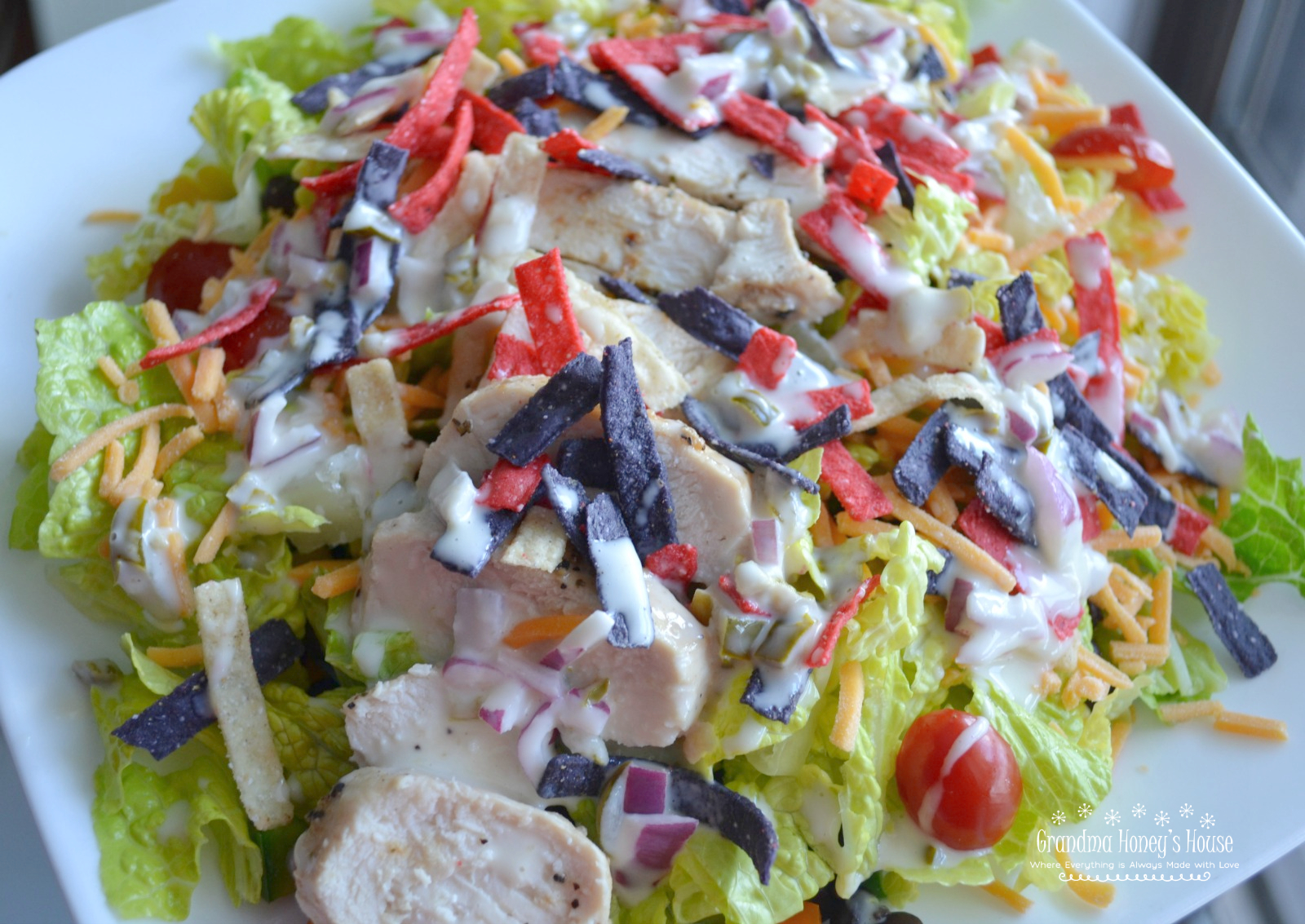 Southwest Chicken Salad is filled with southwest inspired ingredients like black beans, corn, grilled chicken, peppers, tomatoes and topped with a homemade jalapeno dressing.