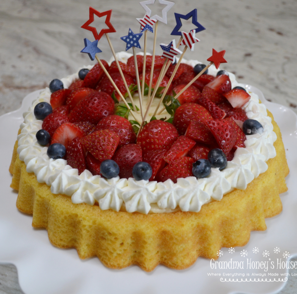Strawberry Mascarpone Cream Cake is a light elegant summer dessert baked in a tiara pan. 4th of July cake decorated.